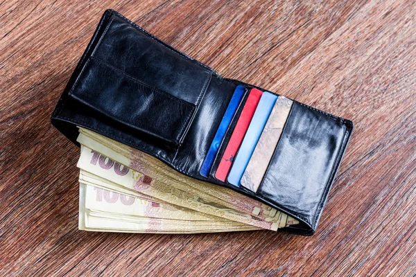 depositphotos_99192670-stock-photo-leather-black-wallet-with-ukrainian